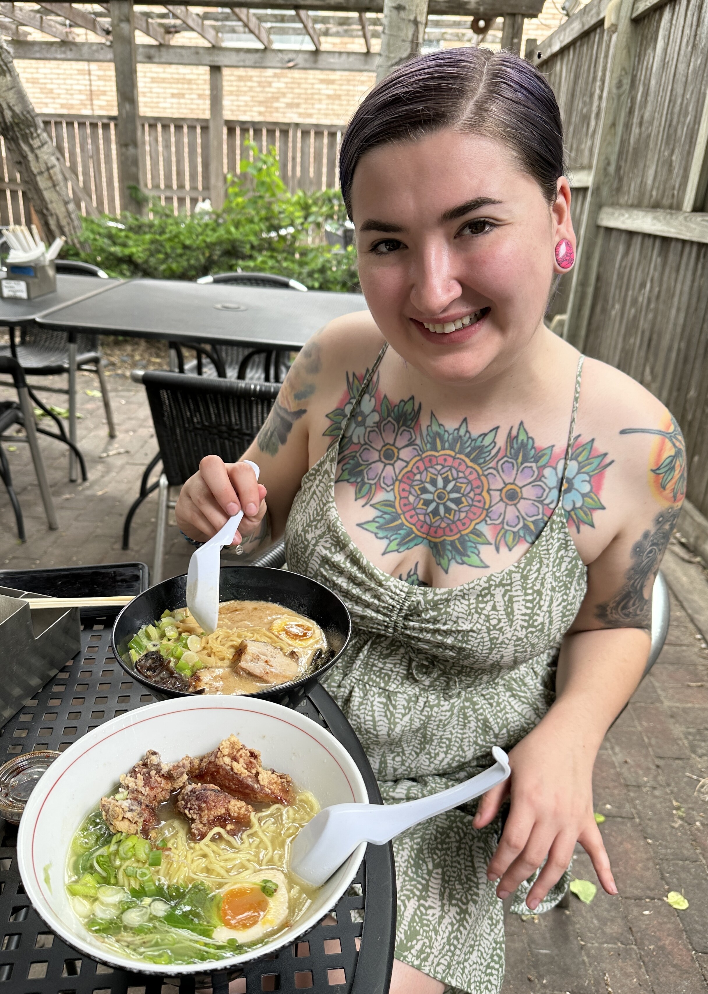 My daughter on the back patio at Raman Kazama in Minneapolis with bowls of shoyu and torishio ramen