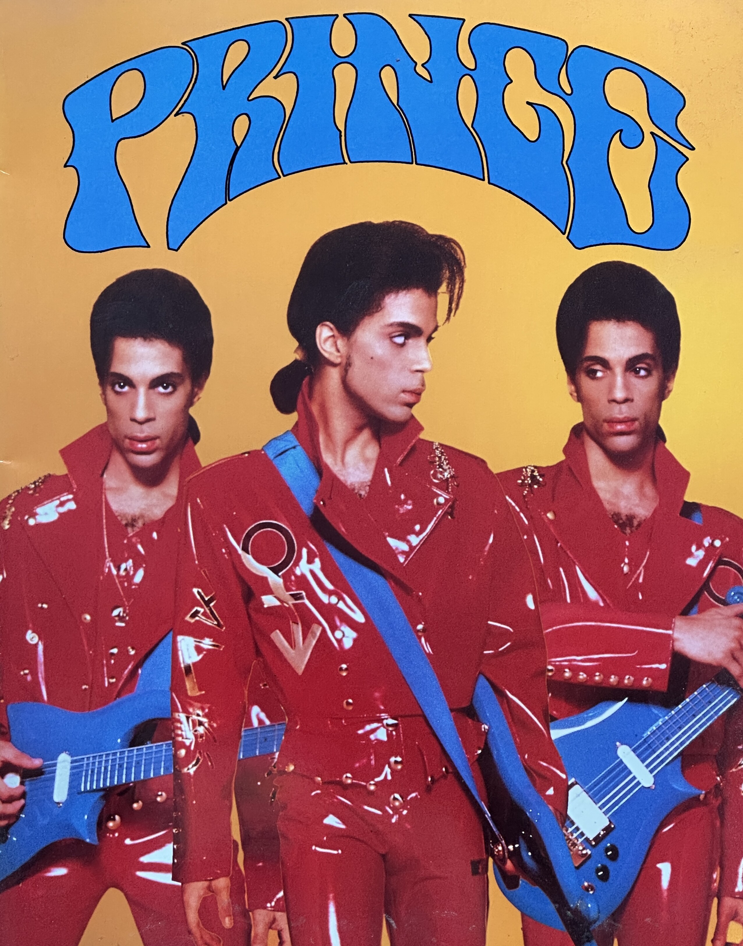 Prince magazine cover with theee shots of Prince in a red suit and blue guitar